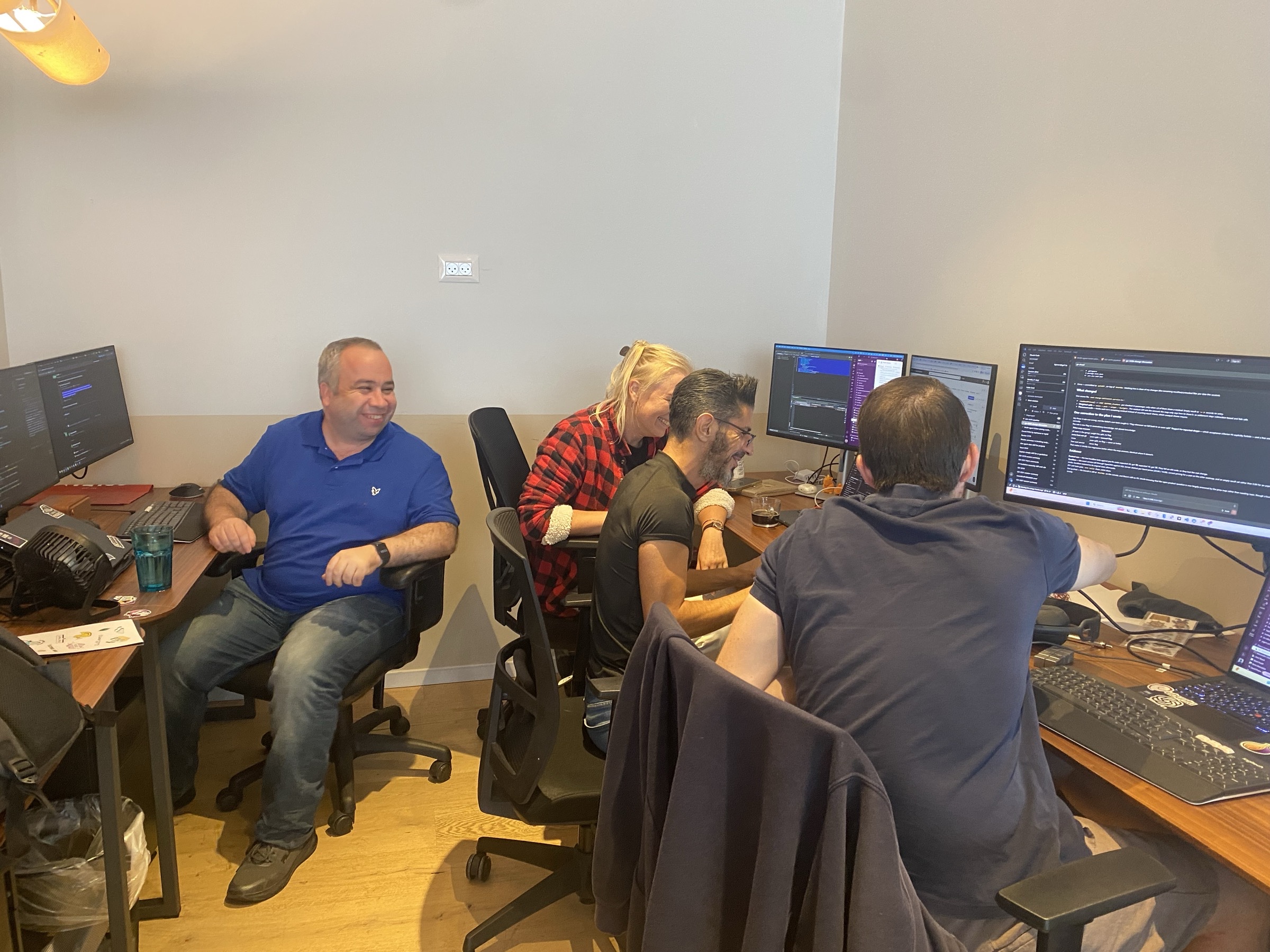 GO7 teammates collaborating at desks during a hackathon coding session